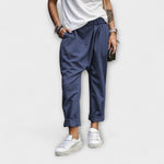 Navy blue wide-leg pants with cuffed ankles and relaxed fit.