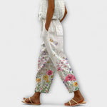 Wide-leg floral printed pants on off-white with colorful blossoms, drawstring waist