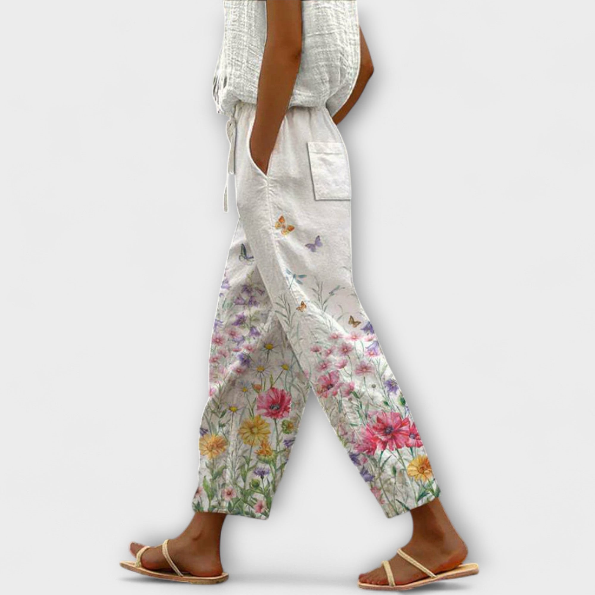 Wide-leg floral printed pants on off-white with colorful blossoms, drawstring waist