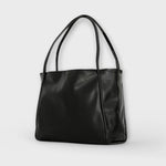 Black leather-look tote bag with two handles and smooth front panel